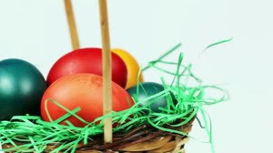 stock-footage-easter-eggs-background-colorful-easter-eggs-in-a-basket-with-green-grass-decoration-white-300x168